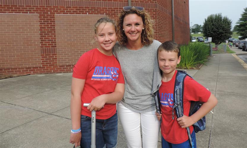 A mother and two sons smile